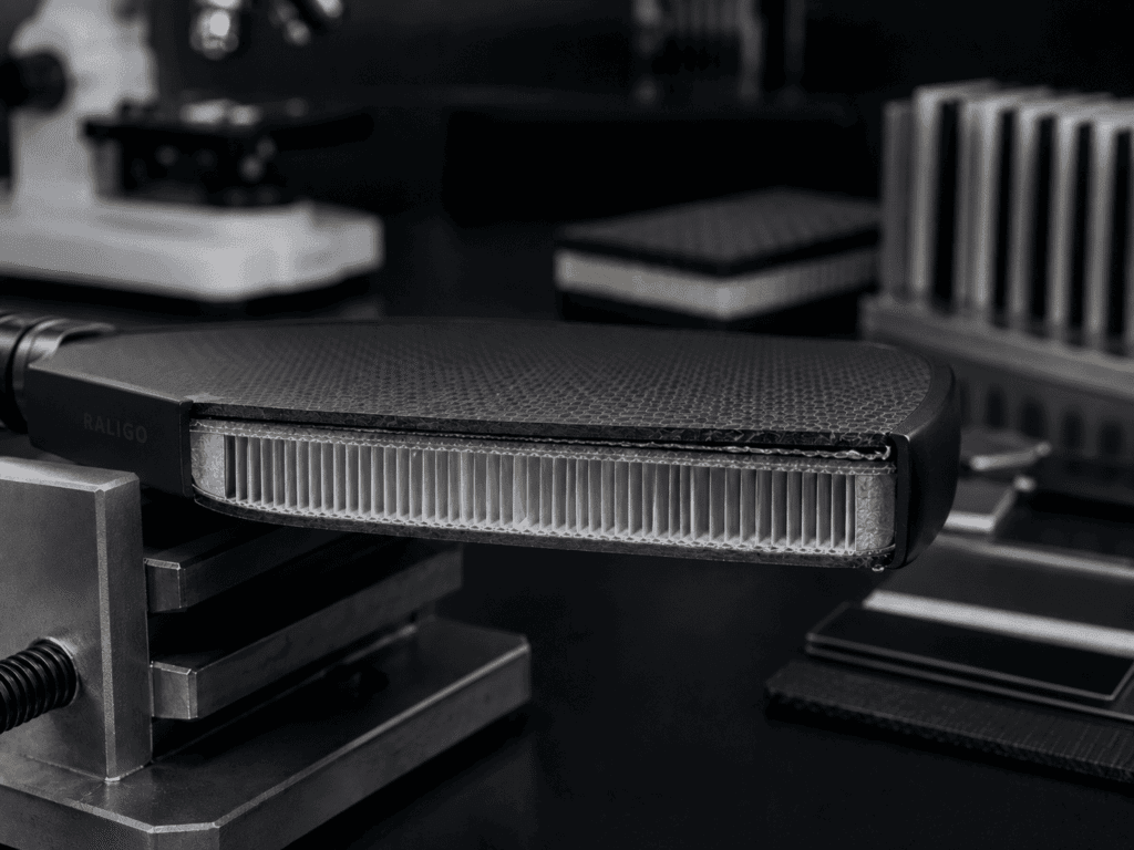Cross-section showing moisture ingress, adhesive degradation, and early delamination in a carbon fiber pickleball paddle